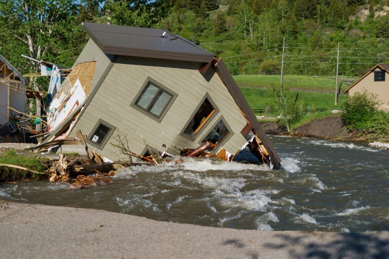 A house sits in Rock Creek after floodwaters washed away a road and a bridge in Red Lodge, Mont., in 2022.