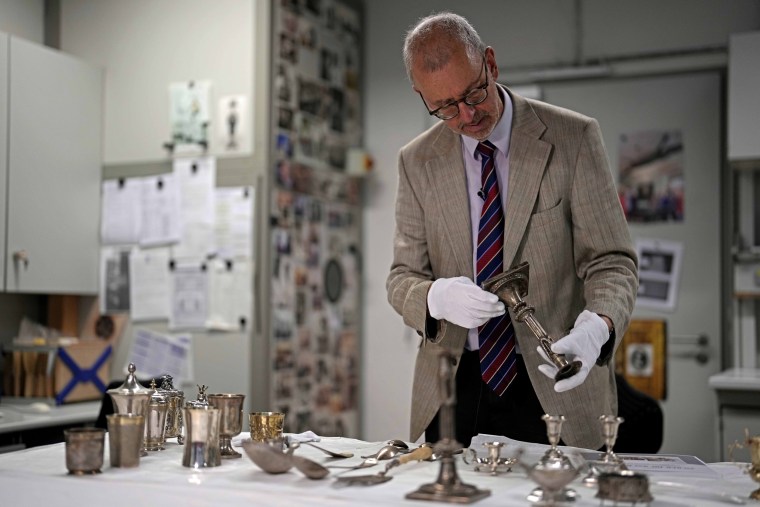 Matthias Weniger holds up one of the 111 silver items stolen by the Nazis from Jews during the Third Reich, in Munich, Germany.