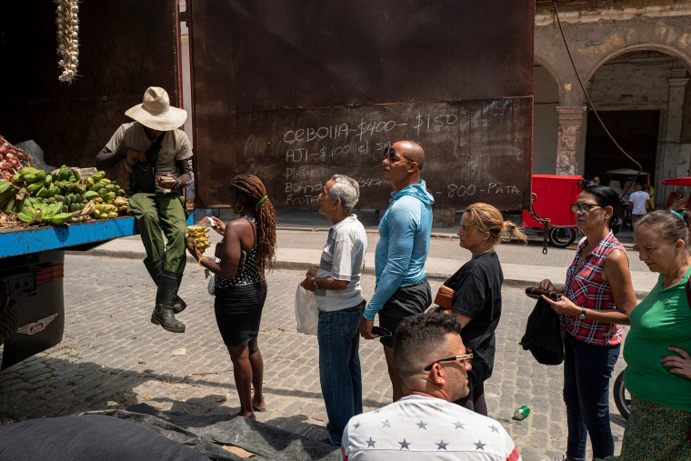 People stand in line to buy food, in Havana, on March 31, 2023.