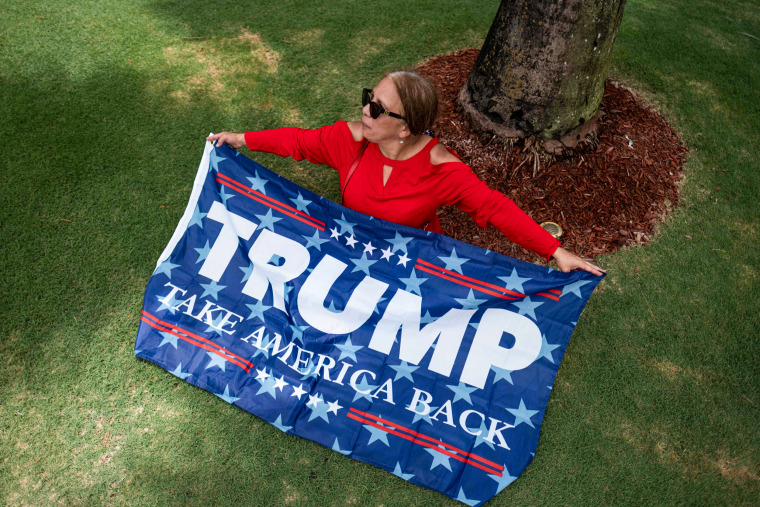 A supporter of former President Donald Trump sits outside Trump National Doral resort in Doral, Fla., on June 12, 2023.