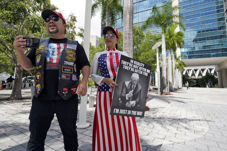 Supporters of Donald Trump, Binh Vo, left and his wife Trang Ngoc, stand outside the Wilkie D. Ferguson Jr. U.S. Courthouse in Miami