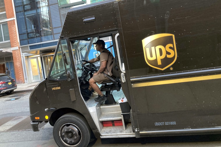 A United Parcel Service driver pilots his truck, in New York, Thursday, May 11, 2023. More than 340,000 unionized United Parcel Service employees, including drivers and warehouse workers, say they are prepared to strike if the company does not meet their demands before the end of the current contract on July 31. UPS