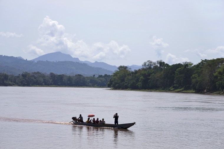 Residents of the Chazuta community travel down the Huallaga River within view of the Cordillera Azul National Park in Peru's Amazon on Oct. 2, 2022. 
