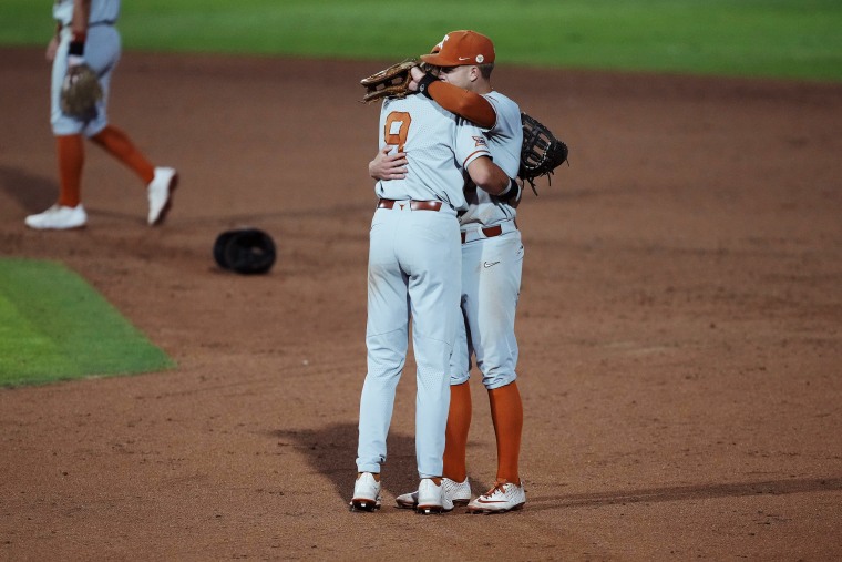 Texas' Jared Thomas and Mitchell Daly, right, hug after a 7-6 loss against Stanford on June 12, 2023.