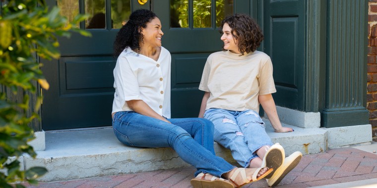 Two women sitting on steps outdoors