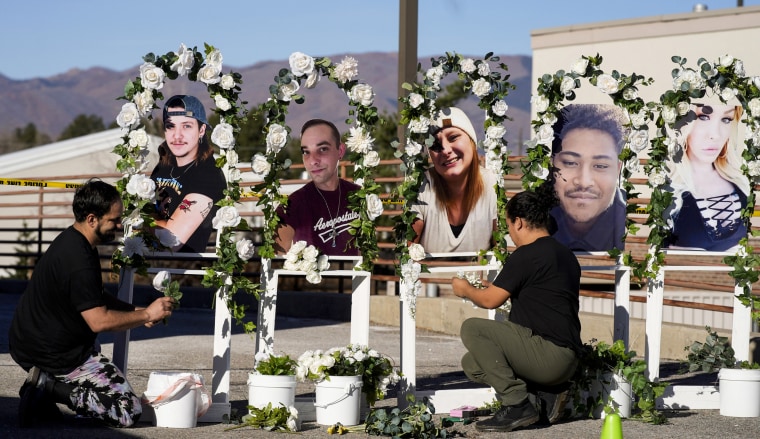 People arrange a memorial on Nov. 22, 2022, for the victims of the mass shooting Club Q in Colorado Springs, Colo.