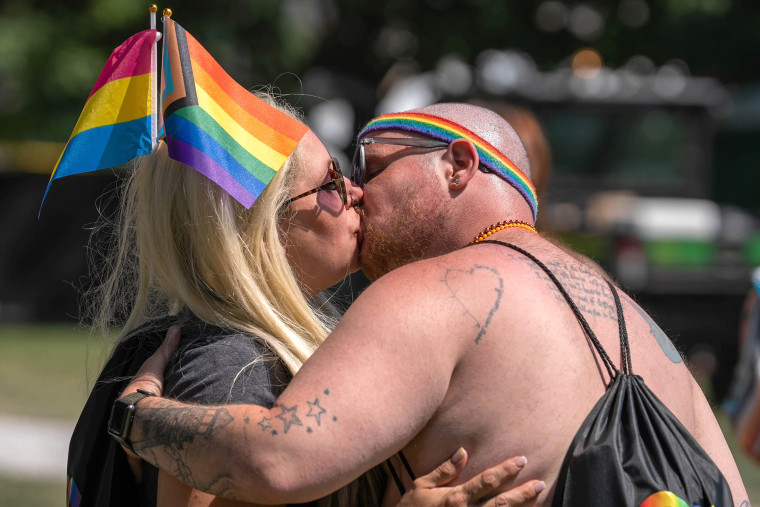 A couple kisses Saturday, June 10, 2023 during the Indy Pride Festival at Military Park in Indianapolis.