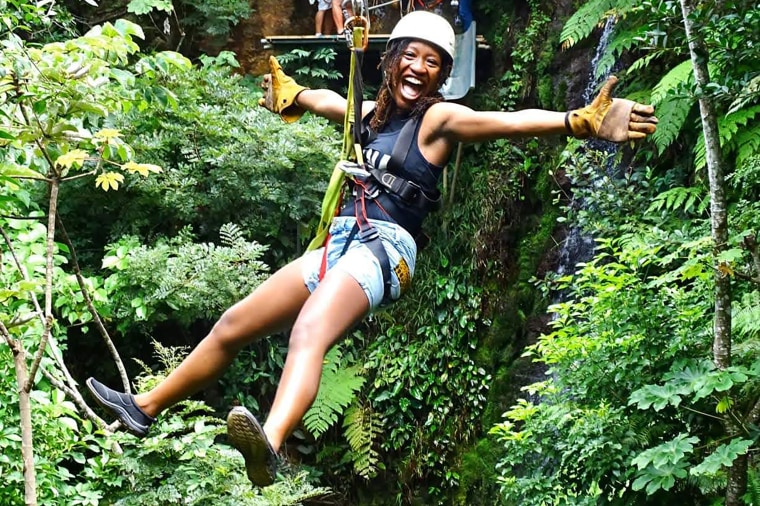 A member of Vibe Tribe Adventures zip-lines in Costa Rica.