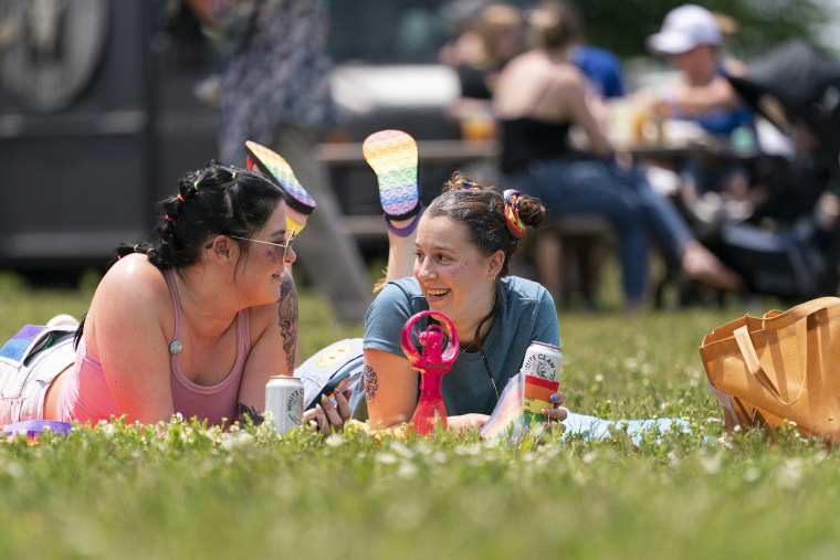 McKenna Dubbert and Sophie Fuller lie on a blanket during the Franklin Pride TN festival, Saturday, June 3, 2023, in Franklin, Tenn.