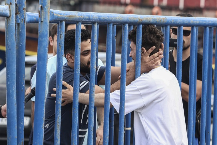 Fadi, right, one of 104 people who were rescued from the Aegean Sea after their fishing boat crammed with migrants sank, reunites with his brother Mohammad in Kalamata, Greece, on June 16, 2023.