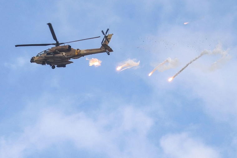 An Israeli Air Force AH-64 Apache attack helicopter releases a payload during an Israeli army raid  in the West Bank city of Jenin on June 19, 2023.