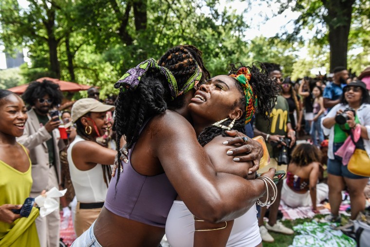 People hug during a Juneteenth celebration in Fort Greene parkin Brooklyn, N.Y., on June 18, 2023.