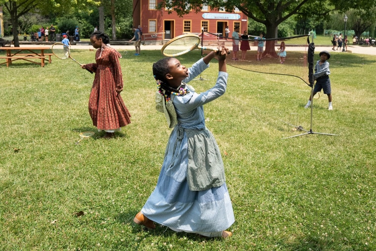 From left: Kennedy Gibbs, 12, Karinne Gibbs, 8, and Anthony Gibbs, dressed in period clothing, play badminton at the Juneteenth Jubilee Day Festival in the Ohio Village on the grounds of the Ohio History Center in Columbus on Sunday. 