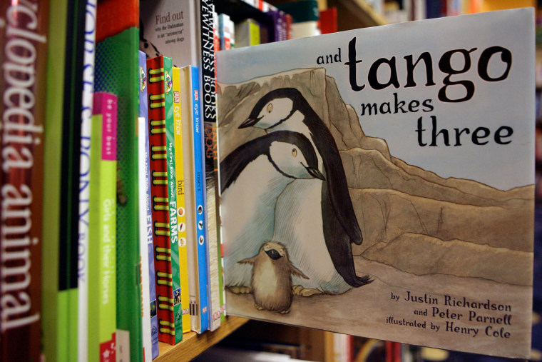 A copy of "And Tango Makes Three" on a bookshelf.