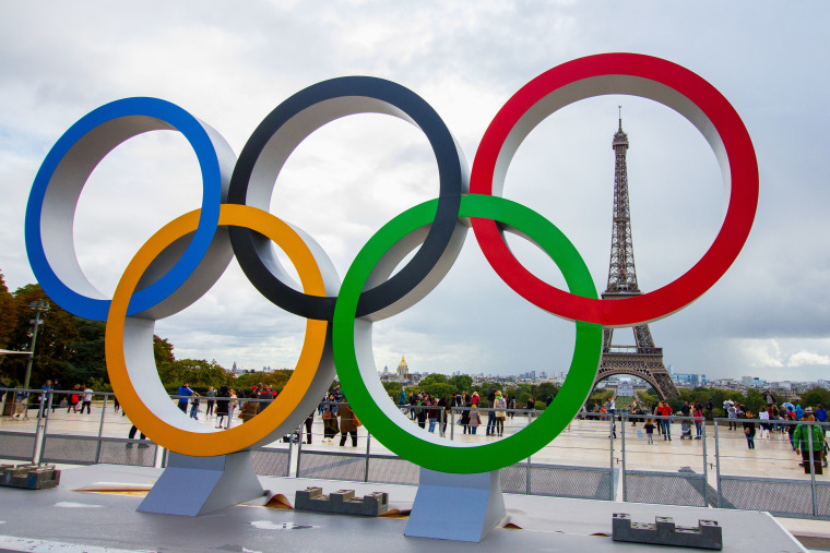 The Olympic Rings being placed in front of the Eiffel Tower