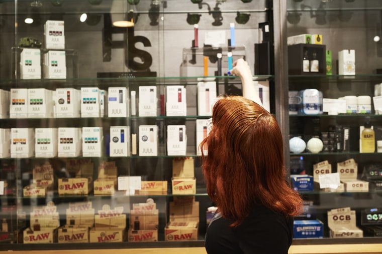An employee organizes e-cigarettes in a store in New York.