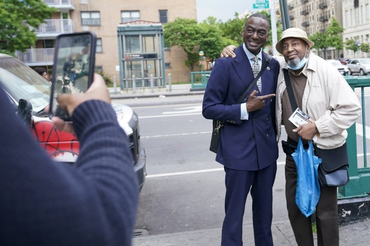 Yusef Salaam, center, takes a photo with a Harlem resident while canvasing in the neighborhood, in New York