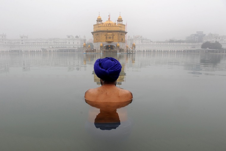 An Indian Sikh devotee takes a holy dip in the sarovar, the water tank, of The Golden Temple in Amritsar during Basant Panchami, the Festival of Spring, celebrated mainly in the northern Indian states of Haryana and Punjab to welcome spring.
