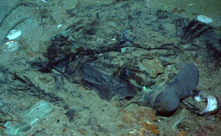 Image: The remains of a coat and boots buried in mud near the Titanic wreckage's stern in 2004.