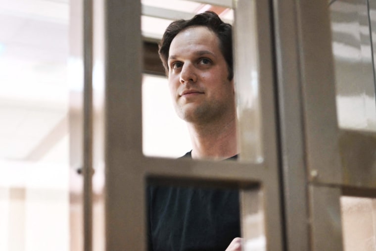 Evan Gershkovich stands inside a defendants' cage at The Moscow City Court