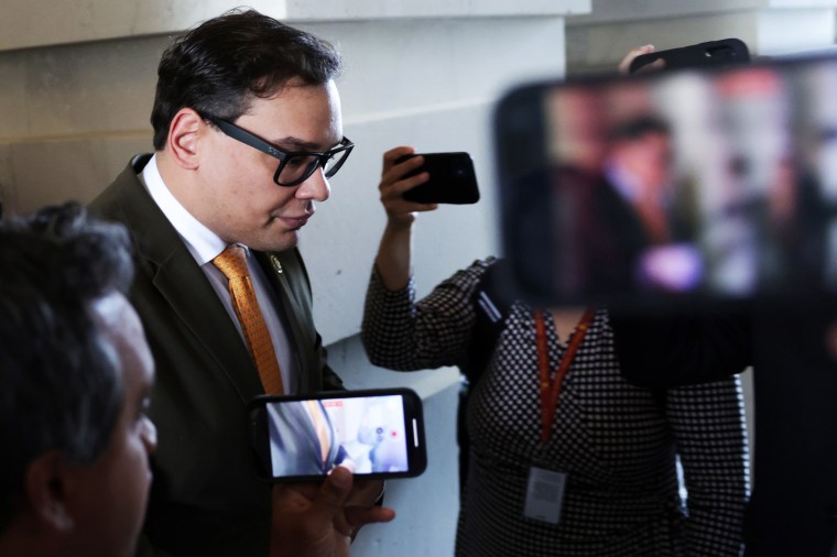 Rep. George Santos leaves the Capitol while surrounded by people recording him with cell phones