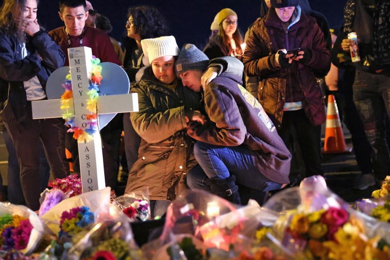 People visit a makeshift memorial near the Club Q nightclub on Nov. 21, 2022 in Colorado Springs, Colo.