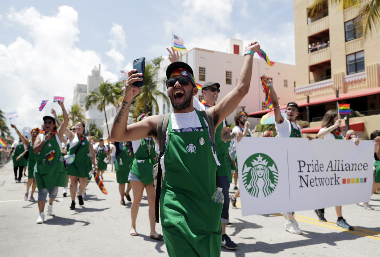 People with the Pride Alliance Network, sponsored by Starbucks, walk along Ocean Drive, as part of Miami Beach Pride week in 2019.