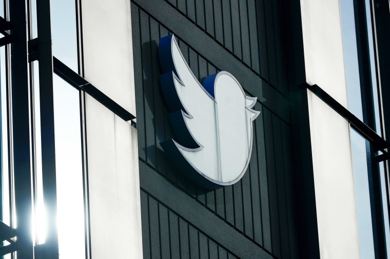 A Twitter logo hangs outside of the company's office