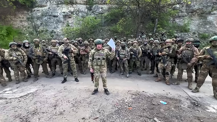 This video grab taken from a handout footage posted on May 5, 2023 on the Telegram account of the press-service of Concord -- a company linked to the chief of Russian mercenary group Wagner, Yevgeny Prigozhin -- shows Yevgeny Prigozhin addressing the Russian army's top brass standing in front of Wagner fighters at an undisclosed location. - The head of Russian paramilitary group Wagner on Friday threatened to pull his fighters from the front line in Bakhmut in eastern Ukraine on May 10, saying ammunition shortages meant they faced "senseless death". "On May 10, 2023 we will have to hand over our positions in Bakhmut to units of the defence ministry and withdraw Wagner units to rear camps to lick our wounds," Yevgeny Prigozhin said in a written statement on his Telegram channel.
