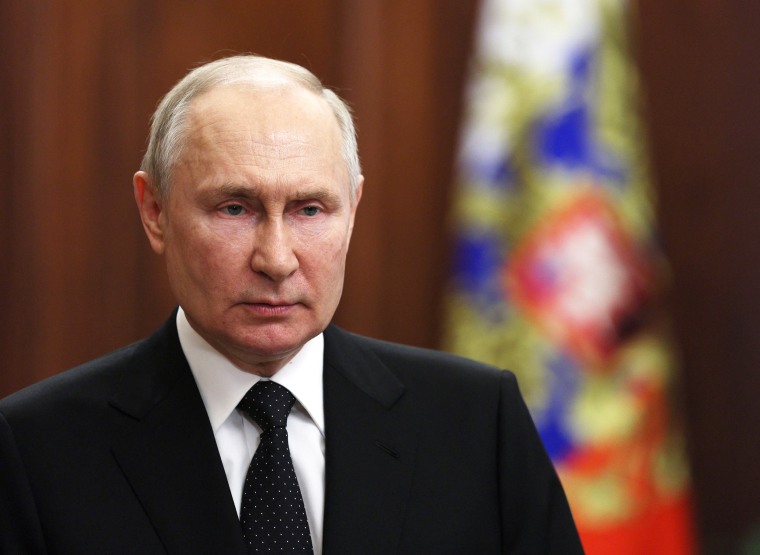 Russia's President Vladimir Putin delivers a video address from the Kremlin