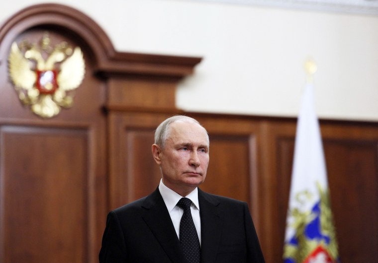Russian President Vladimir Putin delivers a video address to his country from the Kremlin