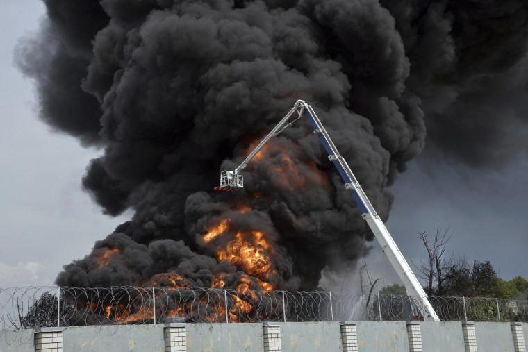 Firefighters work on extinguishing a fire at a fuel depot after reports of an explosion in Voronezh, Russia