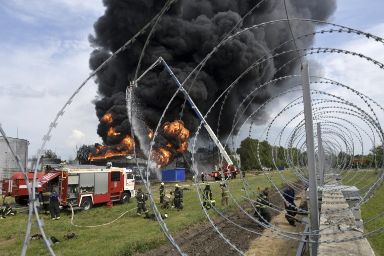 Firefighters work on extinguishing a fire at a fuel depot after reports of an explosion in Voronezh, Russia