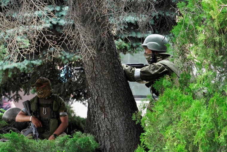 Members of Wagner group stand guard in a street in Rostov-on-Don, Russia