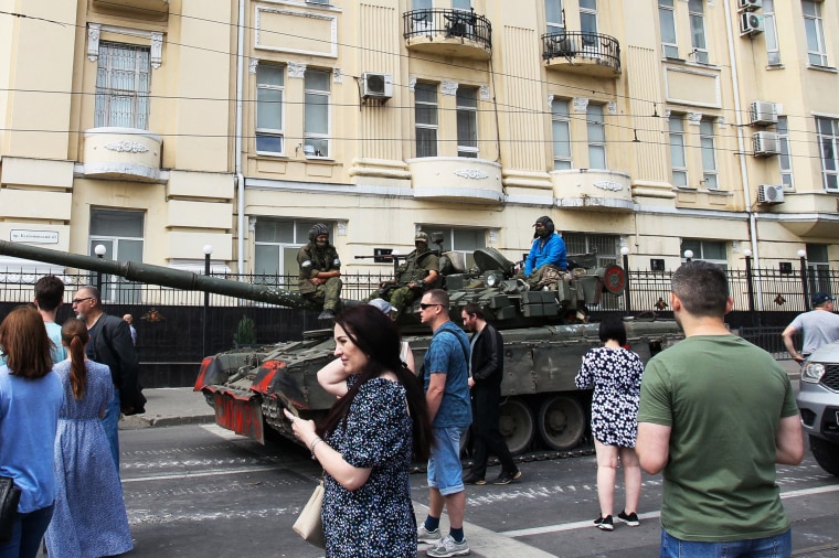 Members of Wagner group sit atop of a tank in a street in Rostov-on-Don, Russia