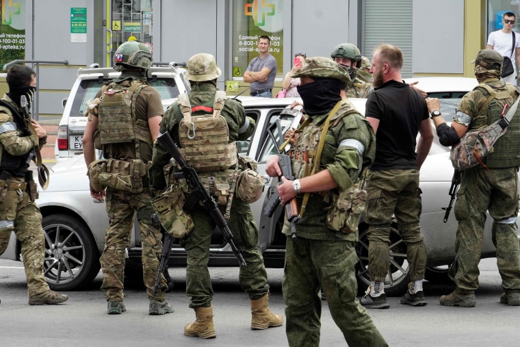 Members of Wagner group inspect a car in a street of Rostov-on-Don, Russia