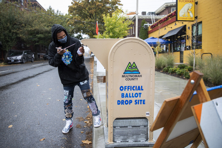Matthew Parker-Hicks drops off his ballot outside the Multnomah County elections office on Election Day in Portland, Ore., on Nov. 3, 2020. Parker-Hicks turned 18 just past the last presidential election in 2016, and said he was excited to be able to vote for the first time this year. "I feel like I'm part of the ecosystem now," he said. (Alisha Jucevic / for NBC News)