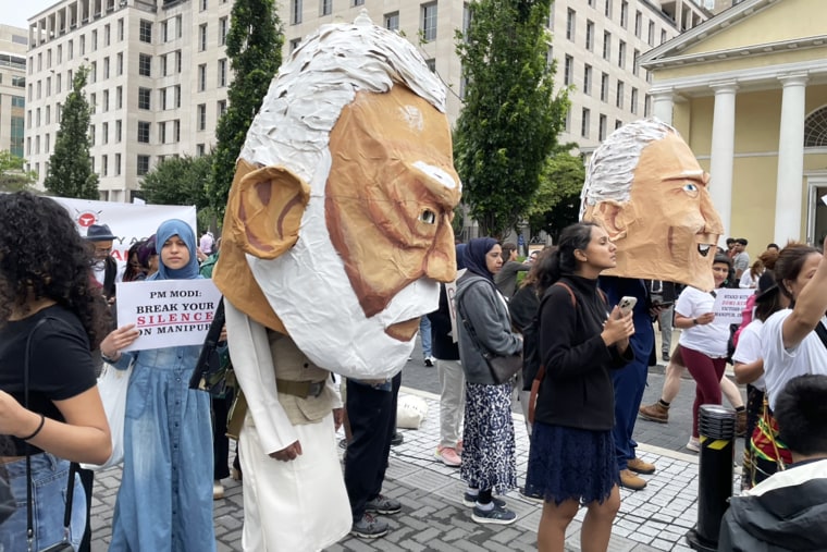 Protestors wear paper-m?ache heads of President Joe Biden and Modi in Washington D.C. on June 22, 2023.