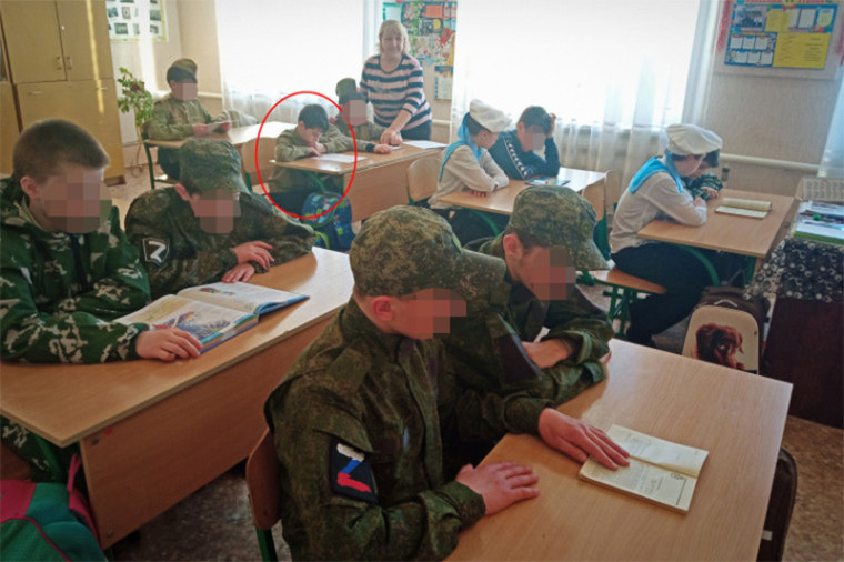 In a photo posted on Perevalsk Special Correctional Boarding School's website, Nikita can be seen reading at his desk during a lesson.