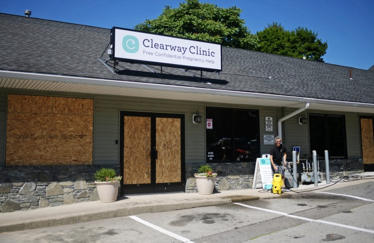 Windows are boarded up at Clearway Clinic, where vandals smashed windows with a hammer on July 7, 2022.