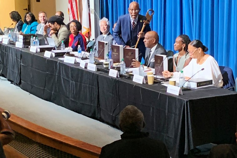 Amos Brown holds an African staff as he speaks during a meeting of the California reparations task force on June 29, 2023. 