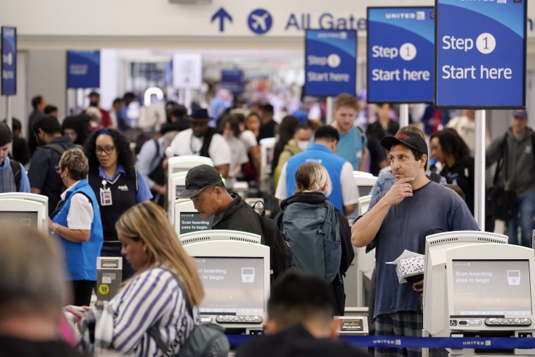 Travelers wait in line at a departure area check-in at Los Angeles International Airport