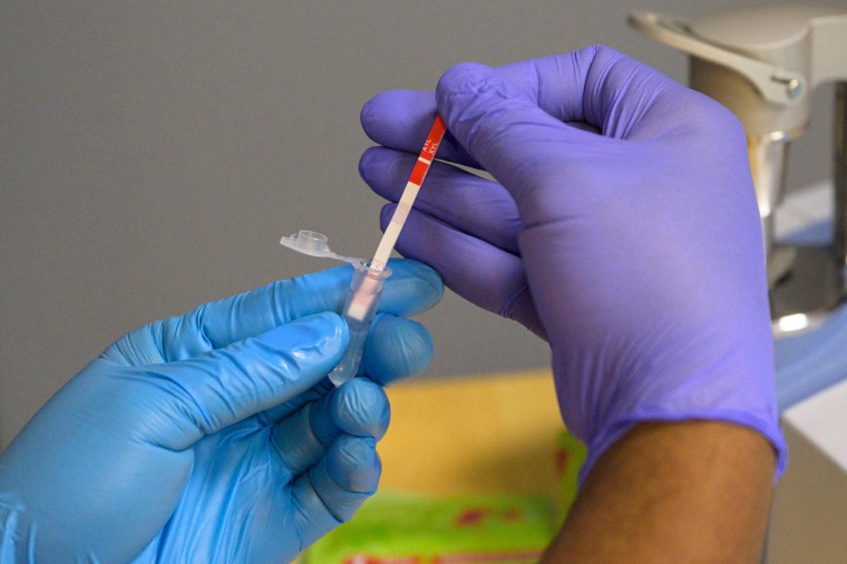 A field researcher with the New York City Department of Health tests a heroin sample for xylazine on May 25, 2023. 