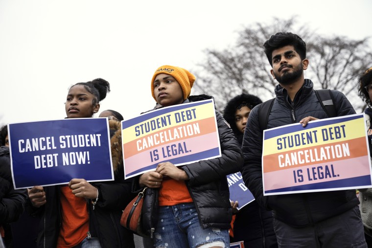 People rally in support of the Biden administration's student debt relief plan in front of the Supreme Court