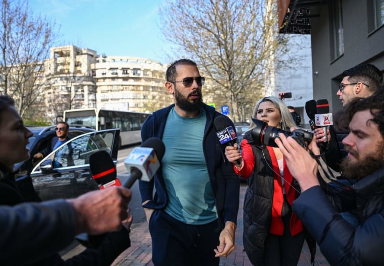 Andrew ‍Tate arrives at the ​Directorate of ‌Organized Crime Research and Terrorism (dicot) to attend an appearance on April 10, 2023.