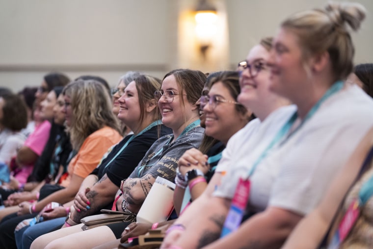 As Colleen Hoover speaks on stage, fans engage at Book Bonanza  on June 23, 2023 in Grapevine, TX. 