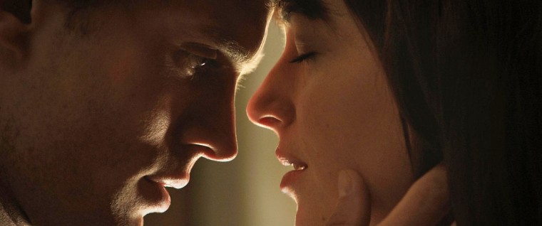 Jamie Dornan as Christian Grey, and Dakota Johnson as Anastasia Steele in "Fifty Shades of Grey."