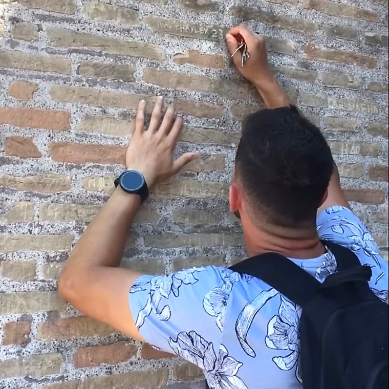 Man carves names in colosseum