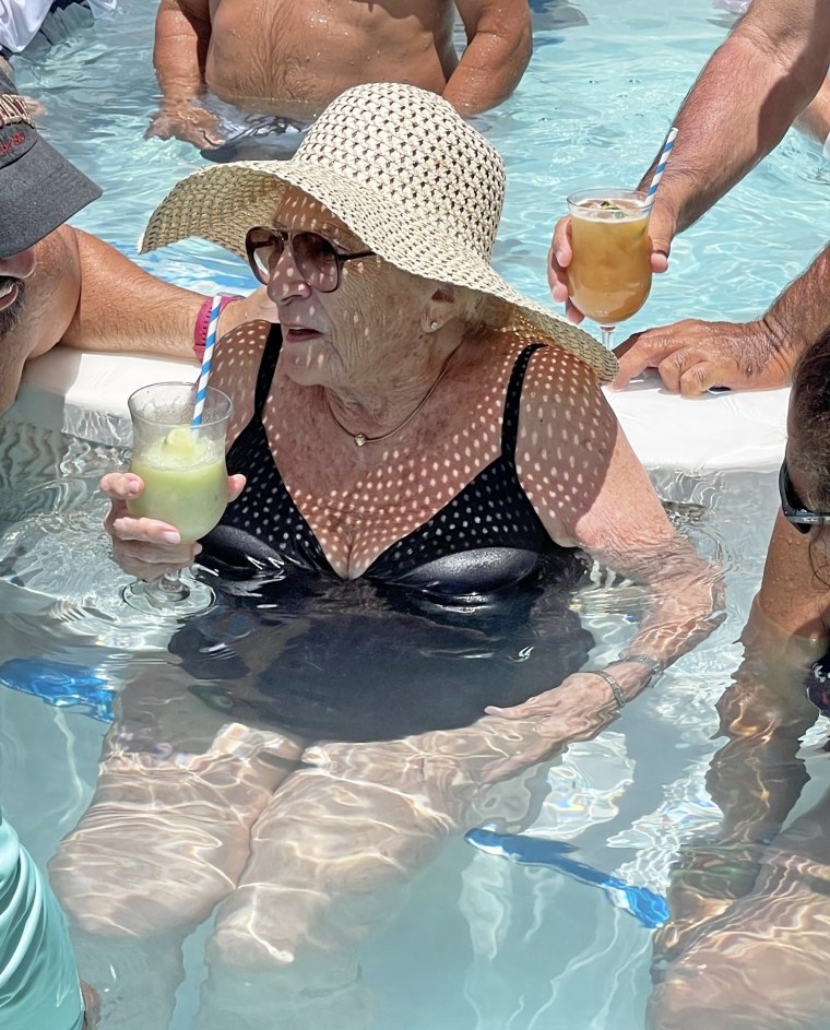 Mildred Kirschenbaum enjoys a drink and good company.