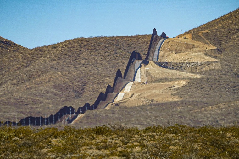 A section of border wall snakes through the Sonoran Desert in Douglas, Ariz., separating Mexico, left, and the United States, in 2020.